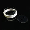 A white isolation box for aquarium fish breeding with suction cups and a clear lid resting on a black surface.