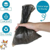 A hand is holding a black biodegradable dog poop bag, illustrating its thick, leak-proof, and eco-friendly features.