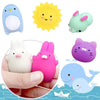 A collection of colorful, squishy animal stress relief toys including a blue penguin, yellow sun, pink rabbit, purple cat, an