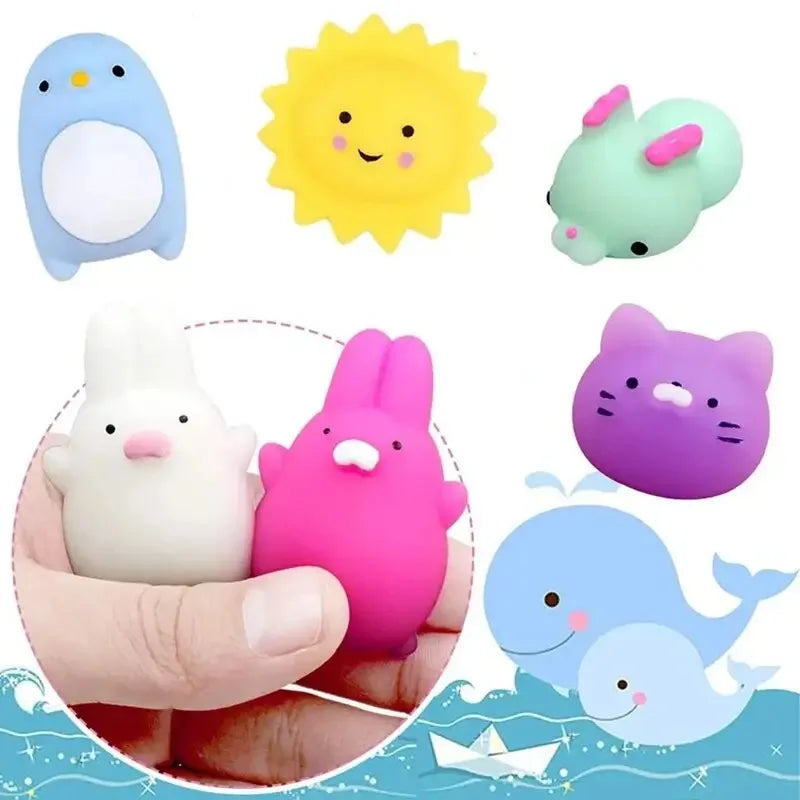 A collection of colorful, squishy animal stress relief toys including a blue penguin, yellow sun, pink rabbit, purple cat, an