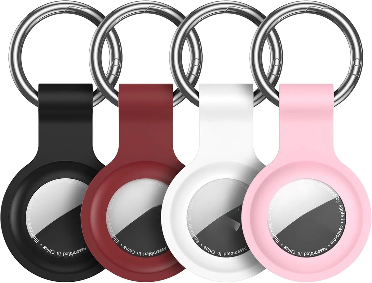 Silicone AirTag protective cover in black, red, white, and pink colors with a keychain ring.