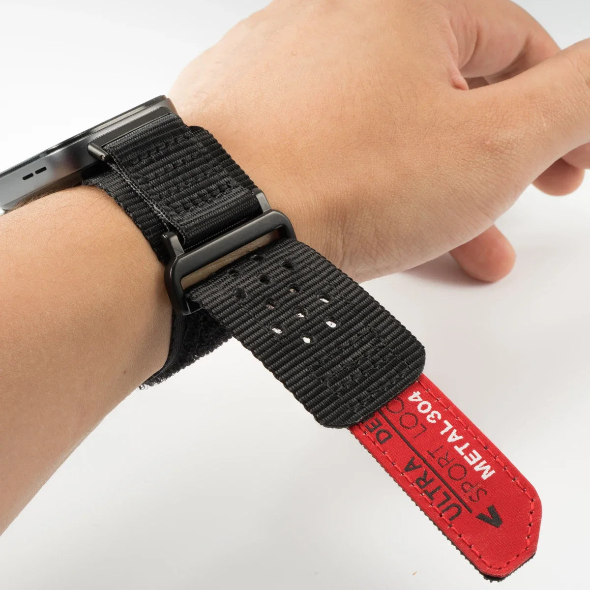 A black nylon sport band for a Huawei watch is shown on a wrist.