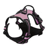 A pink and black adjustable no-pull dog harness with reflective strips and a handle.