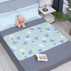 Light blue cartoon patterned waterproof bed protector pad with a teddy bear on a gray bed.