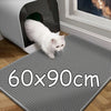 A white cat is standing on a gray honeycomb litter mat placed in front of a white pet enclosure.