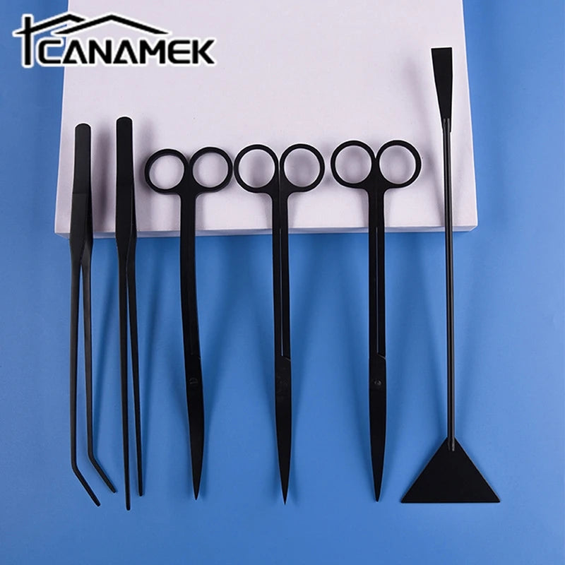 A set of black stainless steel aquarium plant trimming tools including various scissors and forceps.