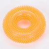 A circular, spiky orange dog chew toy for dental care.