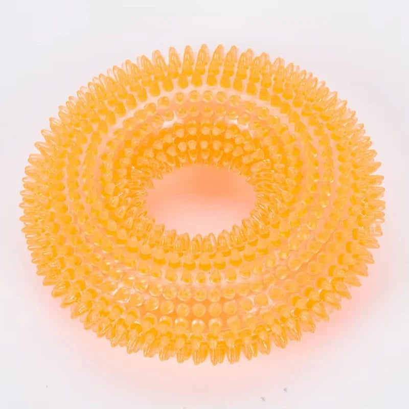A circular, spiky orange dog chew toy for dental care.