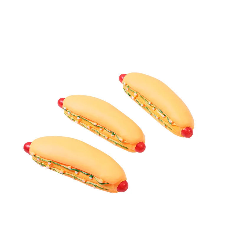 A large hot dog squeaky chew toy for dogs, featuring a yellow bun and meat filling.