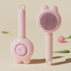 A pink pet deshedding brush for cats and dogs with a self-cleaning design shown in a studio setting.