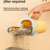 A hand is using a stainless steel cat litter shovel with a gold gap and a clear refill bag to lift dry litter from a pile.