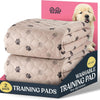 A pack of two beige quilted washable training pads for dogs, shown next to a puppy.