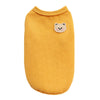 A yellow knitted pet shirt for small dogs or cats featuring a cute bear face patch.