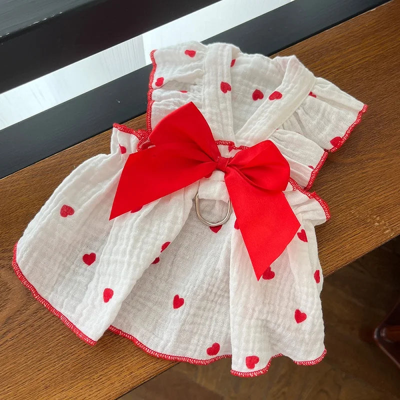 White fabric dress with red polka dots and a large red bow, suitable for a cute strawberry dog.