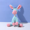 A pink and blue squeaky plush donkey dog toy with large ears and a textured body is displayed against a light purple backgrou
