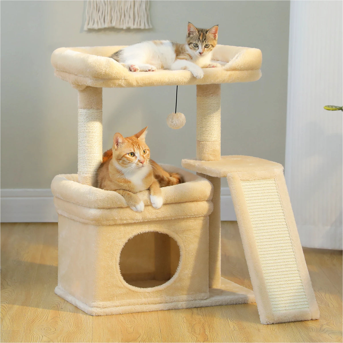 A light beige cat tree with sisal scratching posts and cozy perches, featuring two cats resting on the structure.