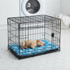A black wire pet crate with a blue mat inside, suitable for a small dog.