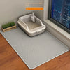 A white double layer cat litter mat with a built-in tray is placed on a gray textured mat indoors.