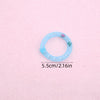 A light blue mesh donut chew toy with a bell, shown against a pink background.