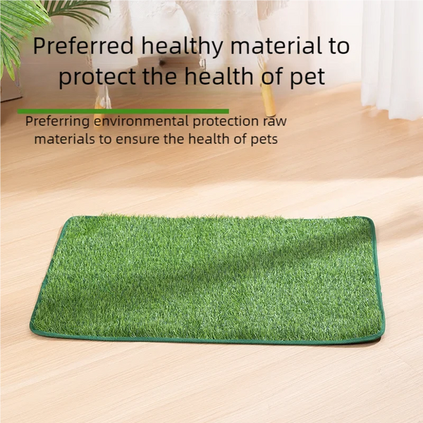 A green artificial grass mat for pets placed on a light wooden floor.