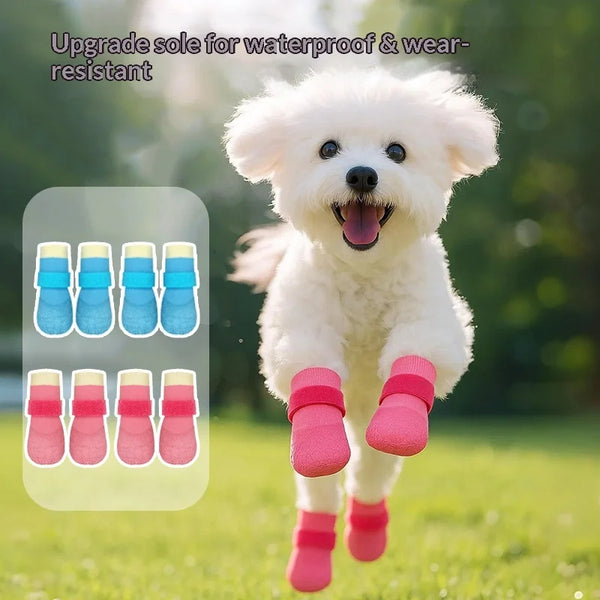 A fluffy white dog is wearing pink waterproof anti-slip boots on a green lawn.