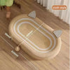 A beige sisal cat scratcher board with a textured surface and a round chew toy shown on a wooden floor.