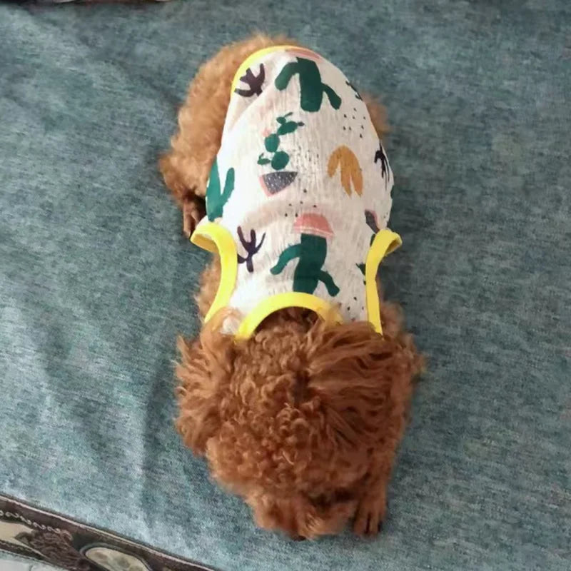 A small dog wearing a breathable summer mesh vest with a green and yellow pattern.