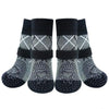 A pair of black knitted anti-slip dog socks with a patterned design.
