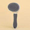A gray pet hair removal brush with a silicone head and a dark gray handle is shown against a light background.