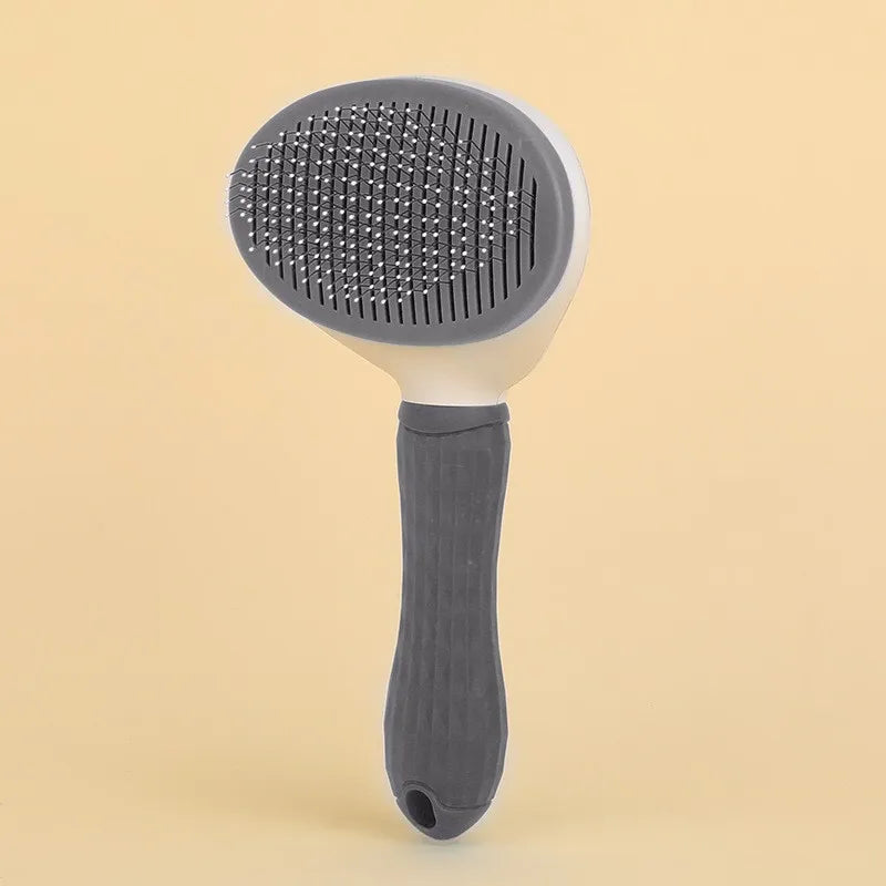 A gray pet hair removal brush with a silicone head and a dark gray handle is shown against a light background.