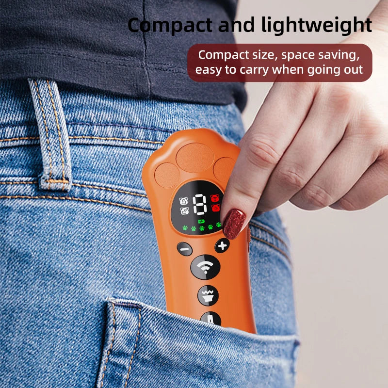An orange paw-shaped ultrasonic dog repeller device is shown being held by a hand, placed in the pocket of blue jeans.
