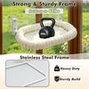 A black dumbbell is hanging from a beige woven hammock suspended by suction cups on a window frame.