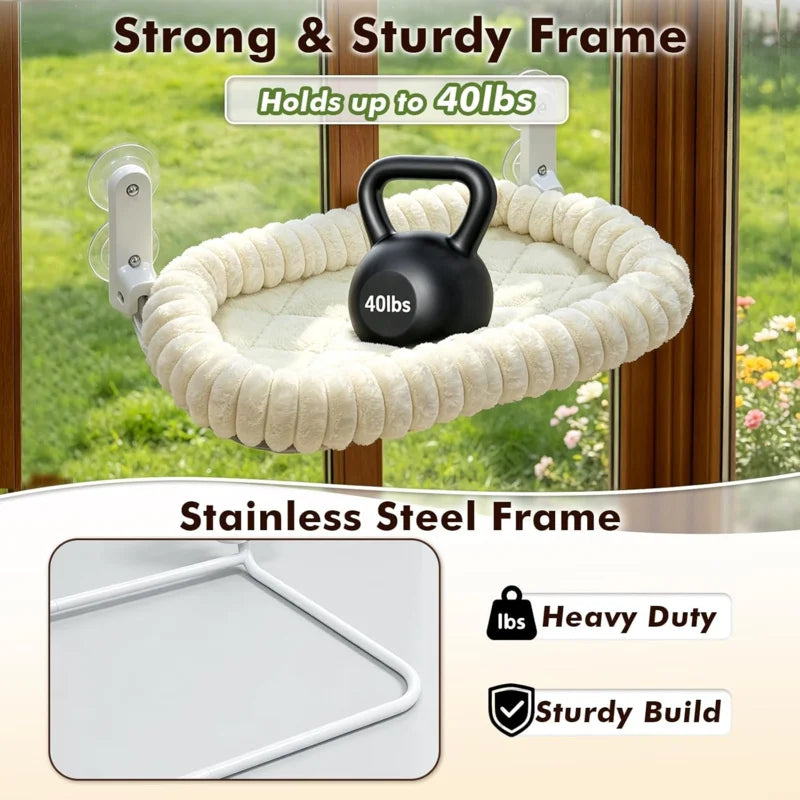 A black dumbbell is hanging from a beige woven hammock suspended by suction cups on a window frame.