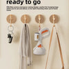 A portable pet poop picker scooper with an ergonomic handle is shown hanging on a wall hook.