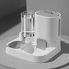 A white 2-in-1 automatic pet feeder and water dispenser unit sitting on a light gray surface.