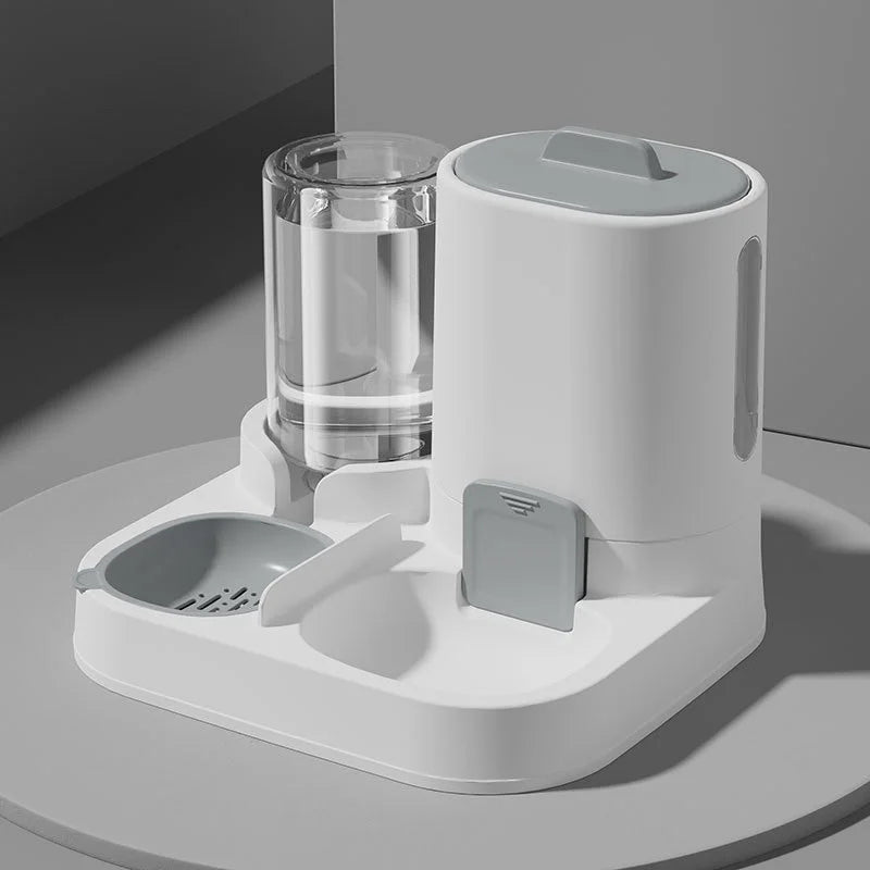 A white 2-in-1 automatic pet feeder and water dispenser unit sitting on a light gray surface.
