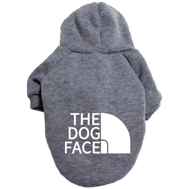 A gray cozy fleece dog hoodie with the text THE DOG FACE printed on the back.