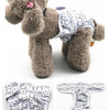 A fluffy brown dog wearing a white reusable female dog physiological panty.