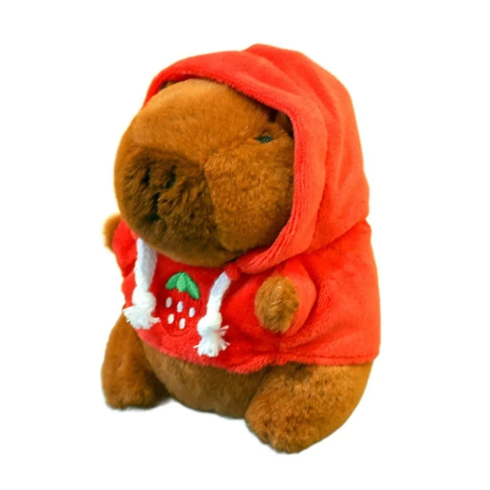 An orange capybara plush doll wearing a bright orange hooded garment.