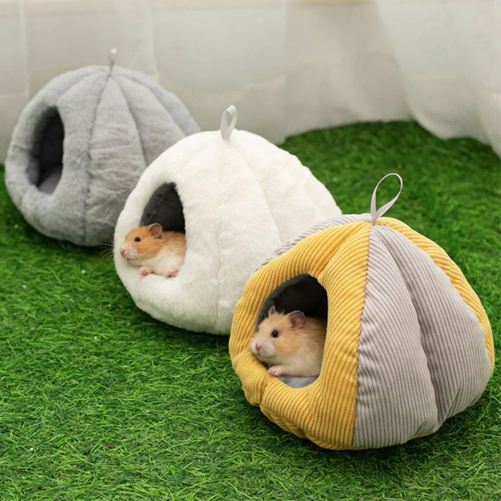 A cozy plush hanging nest in gray and yellow fabric with an entrance for a small rodent.