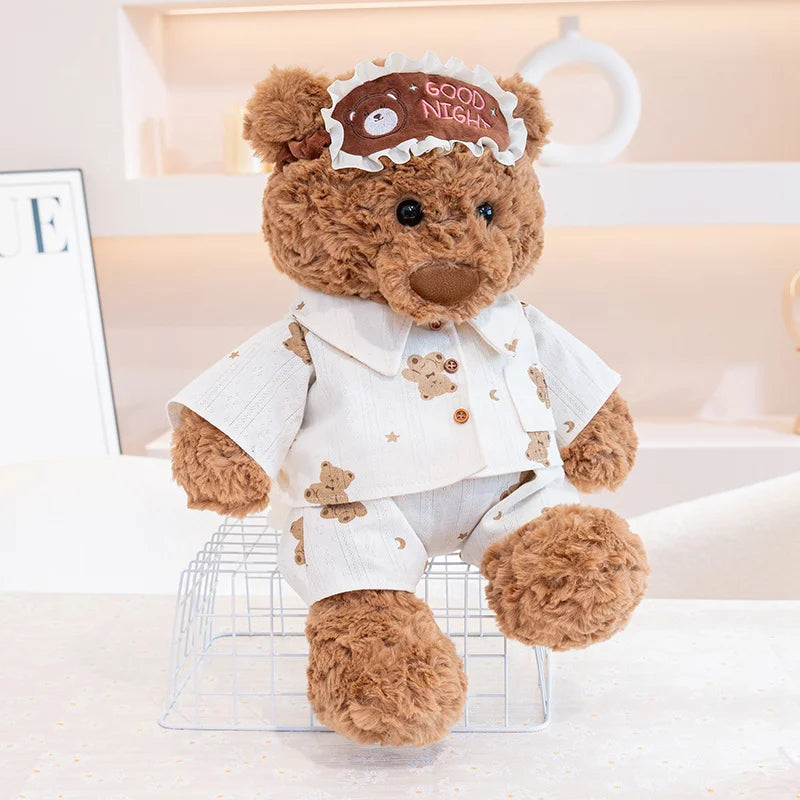 A fluffy brown teddy bear plush wearing a collared shirt and a crown with good night text.