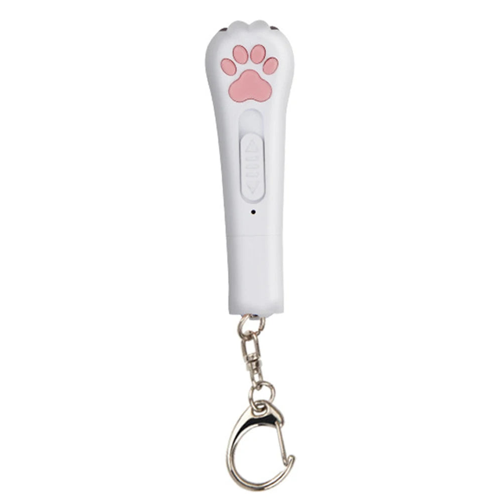 A white pet laser pointer toy with a pink paw print and a metal clip attached.