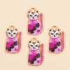 Four pink and black cat pendant charms for jewelry making displayed on a light background.