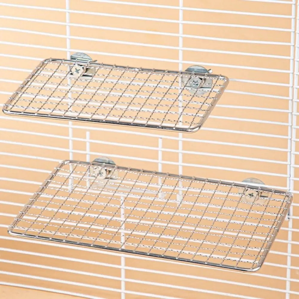 Stainless steel bird perch platform with wire mesh grid mounted on a wall
