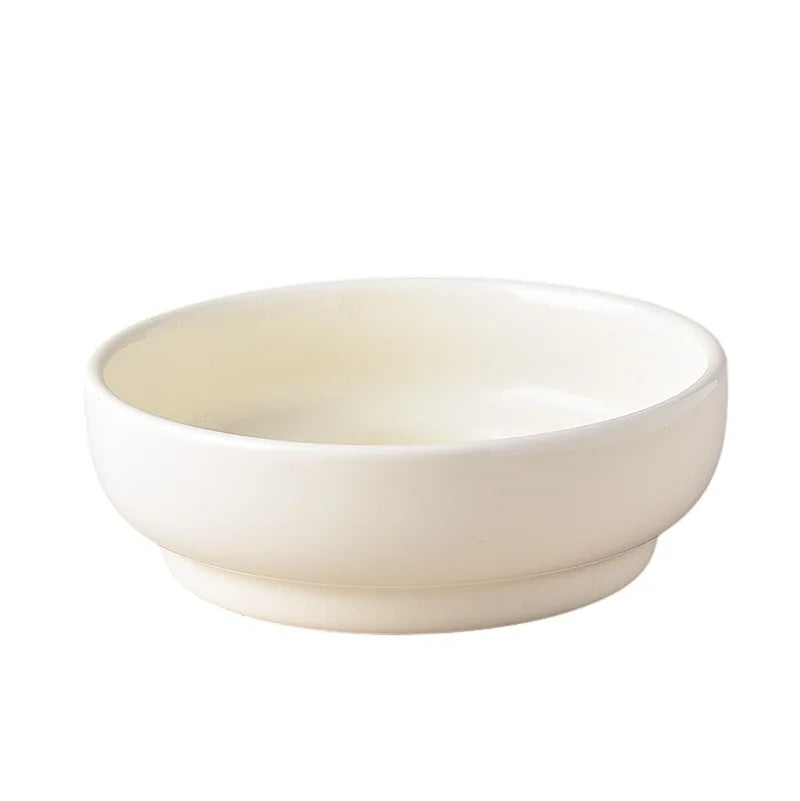 A white ceramic bowl for pets with a matching stand.
