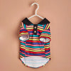 A colorful striped polo shirt for a small dog, featuring horizontal stripes in various bright colors.
