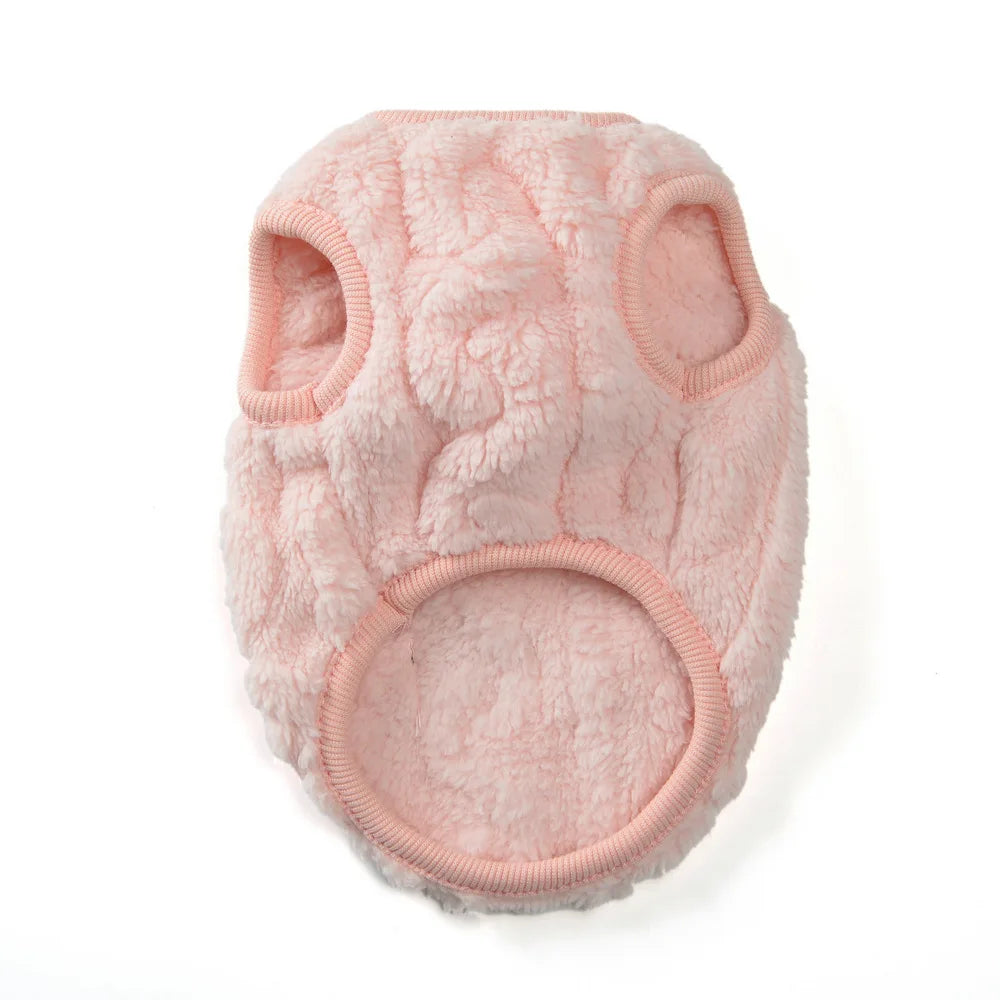A pink, fluffy fleece pet sweater with rounded ears and a large circular opening.