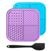 A purple silicone lick mat for pets with suction cups and a black silicone spoon.
