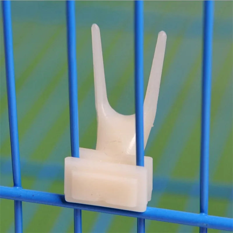 A white bird cage seed catcher skirt made of nylon mesh is shown against a blue wire background.