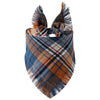 A plaid dog bandana featuring blue, brown, and orange tones with fringed edges.